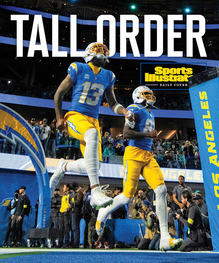 Chargers players run onto the field with the heading TALL ORDER